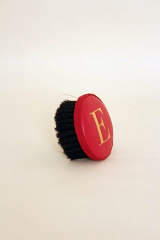 Brush with embossed letter E
