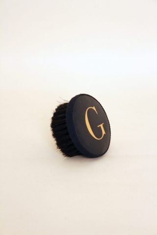 Brush with embossed letter G