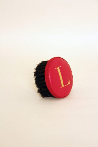 Brush with embossed letter L