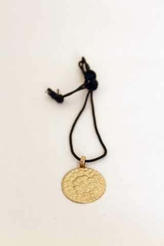 Chiselled and repoussé brass medallion