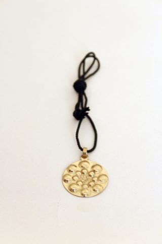 Chiselled and repoussé brass medallion